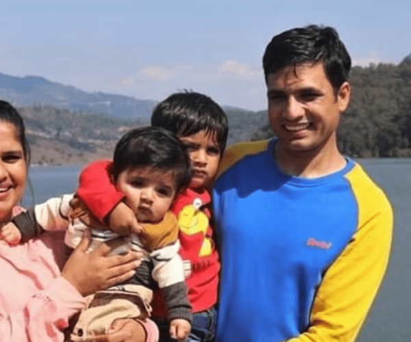 Pastor Keshab and his family by a lake in Nepal
